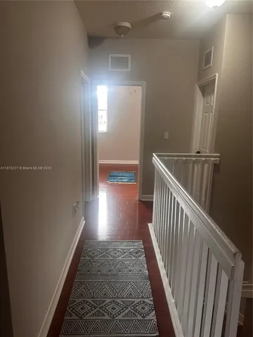 a view of gallery with wooden floor