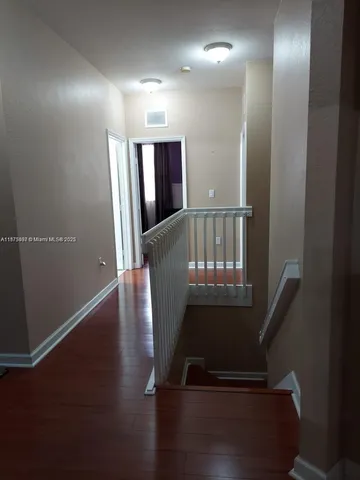 a view of entryway with stairs and wooden floor