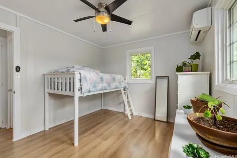 a workspace room with wooden floor and windows