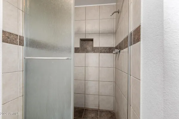 an empty room with a ceiling fan and window