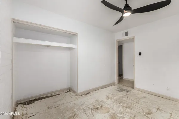 an empty room with a ceiling fan