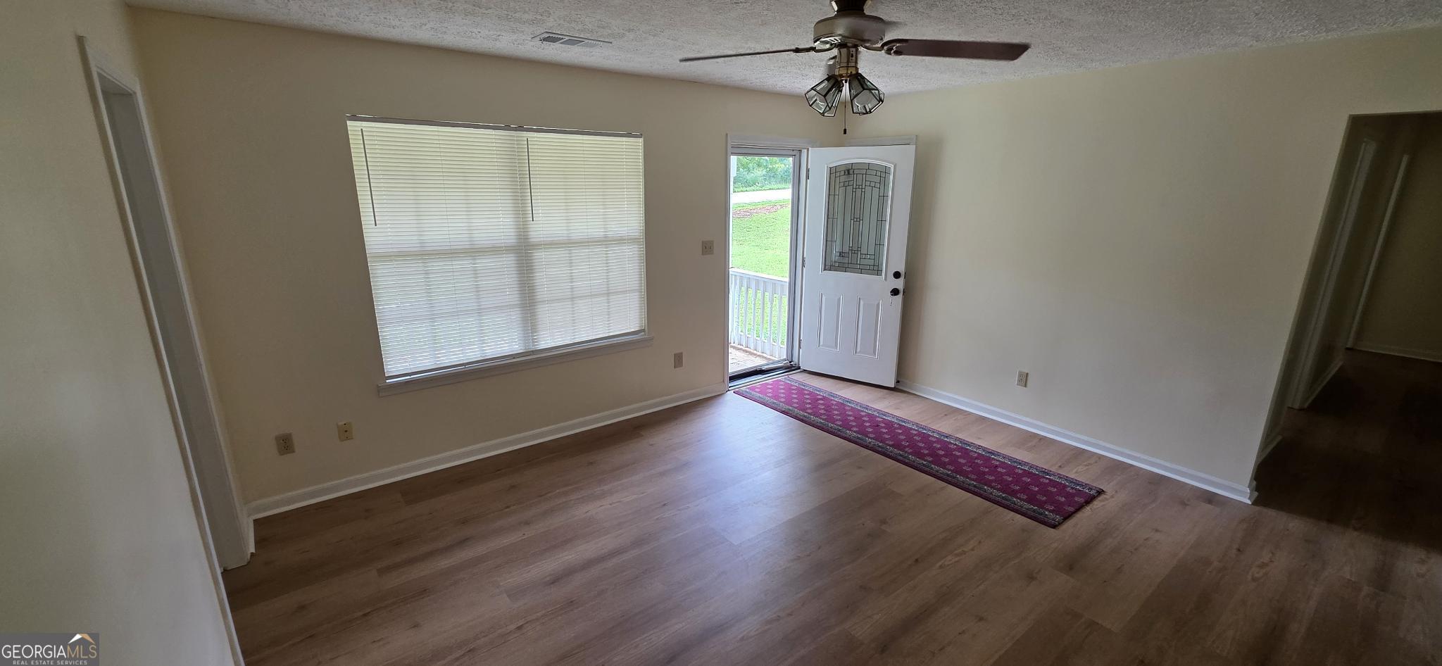 657 Tom McKinley Road Thomaston, GA 30286 - Photo 13 of 33 wooden floor in an empty room with a window