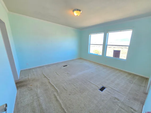 an empty room with a empty space and windows