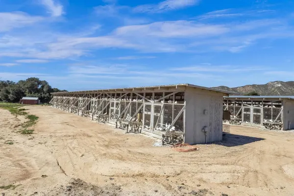a view of a yard with wooden fence