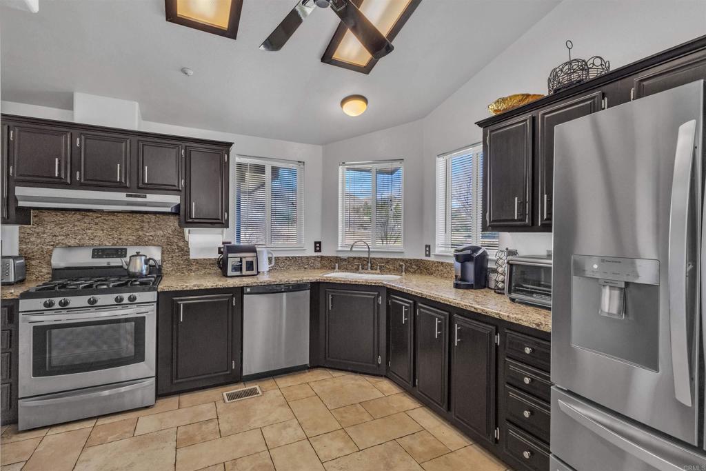 35683 Breezy Lane Ranchita, CA 92066 - Photo 41 of 73 a kitchen with stainless steel appliances granite countertop a sink stove and refrigerator