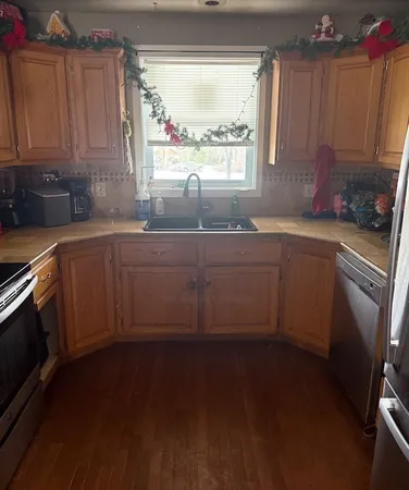 a kitchen with sink cabinets and window