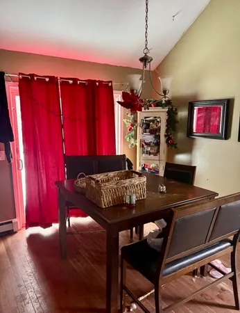 a view of a dining room with furniture and chandelier