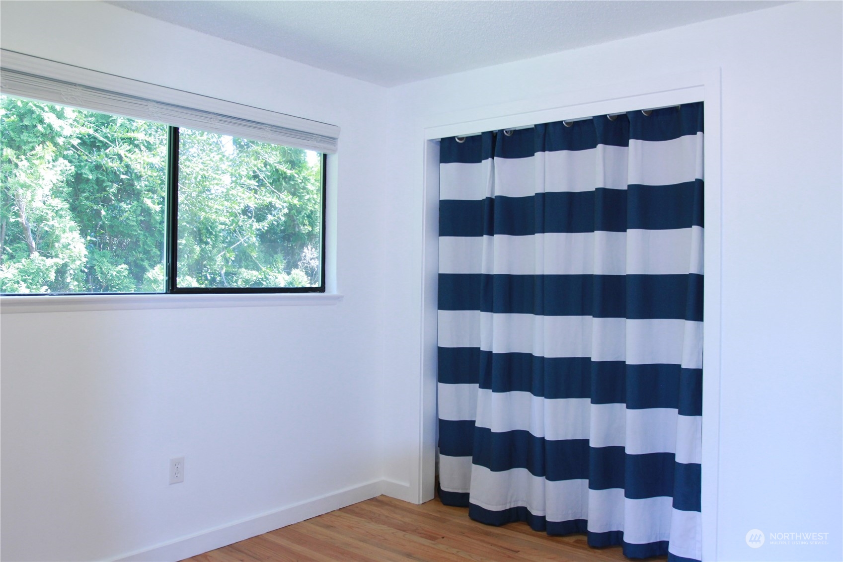 18817 Southeast 134th Street Renton, WA 98059 - Photo 11 of 27 a view of a bedroom with wooden floor and a window