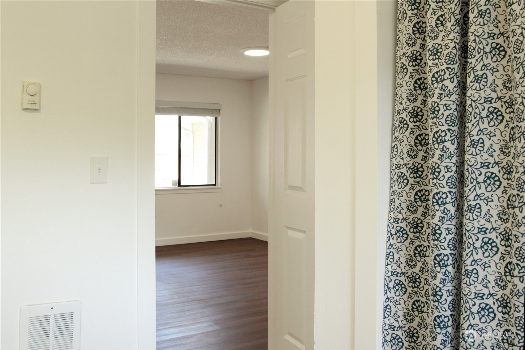 18817 Southeast 134th Street Renton, WA 98059 - Photo 15 of 27 a view of an empty room with wooden floor and a window
