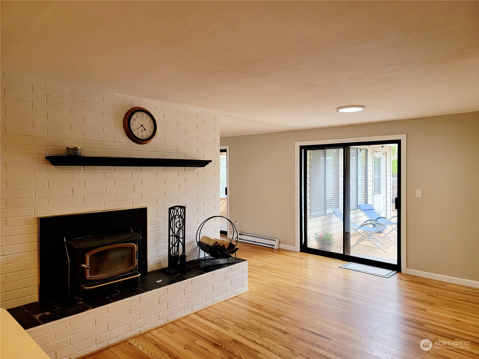 18817 Southeast 134th Street Renton, WA 98059 - Photo 4 of 27 a view of a livingroom with wooden floor and a fireplace