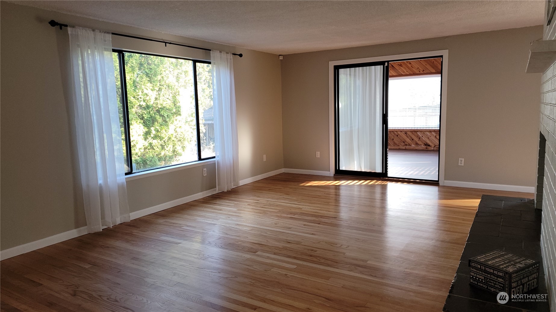 18817 Southeast 134th Street Renton, WA 98059 - Photo 5 of 27 an empty room with wooden floor and windows