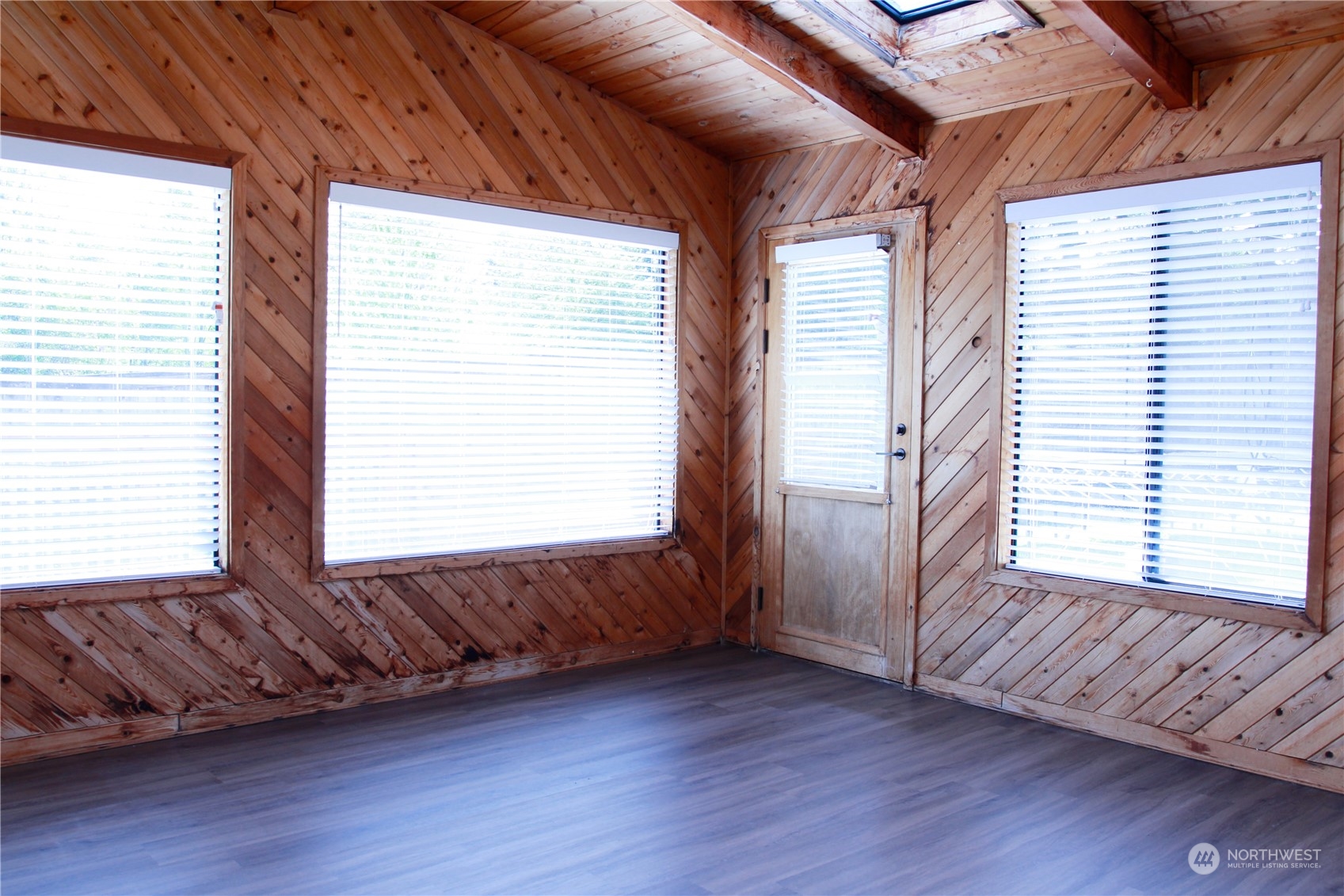 18817 Southeast 134th Street Renton, WA 98059 - Photo 6 of 27 a view of an empty room with wooden floor and a window