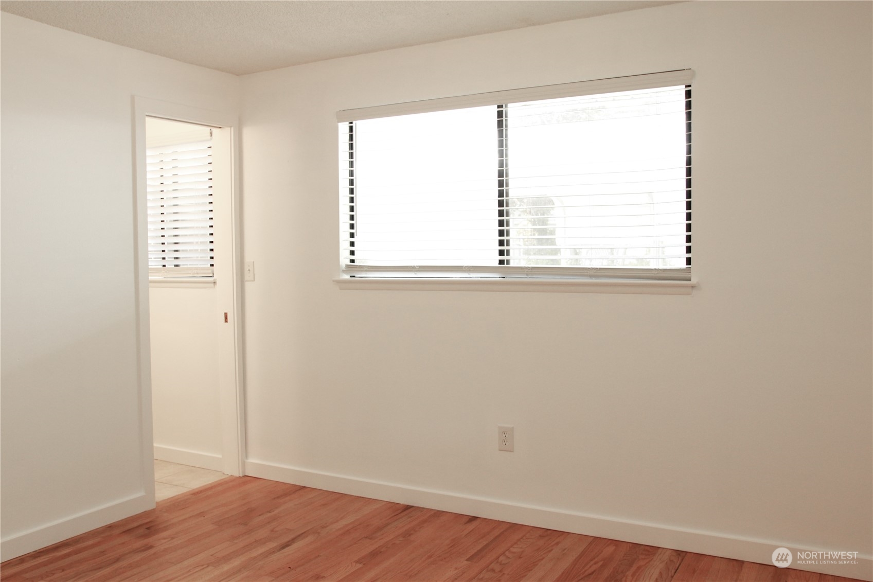 18817 Southeast 134th Street Renton, WA 98059 - Photo 7 of 27 an empty room with wooden floor and windows