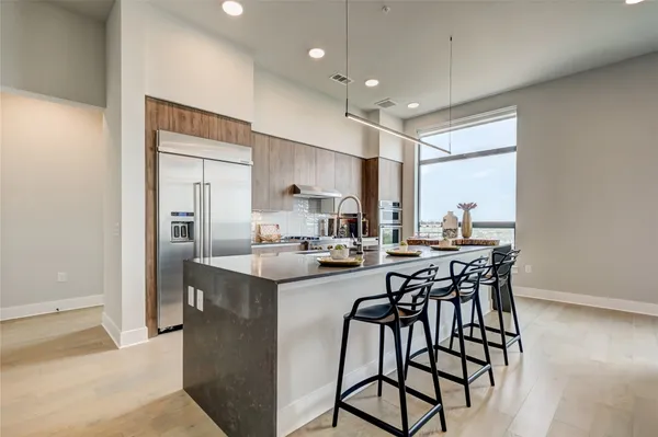 a kitchen with stainless steel appliances kitchen island granite countertop a sink and cabinets