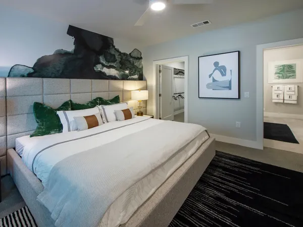 a bedroom with bed and cabinets