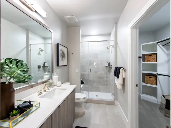 a bathroom with a tub sink and mirror