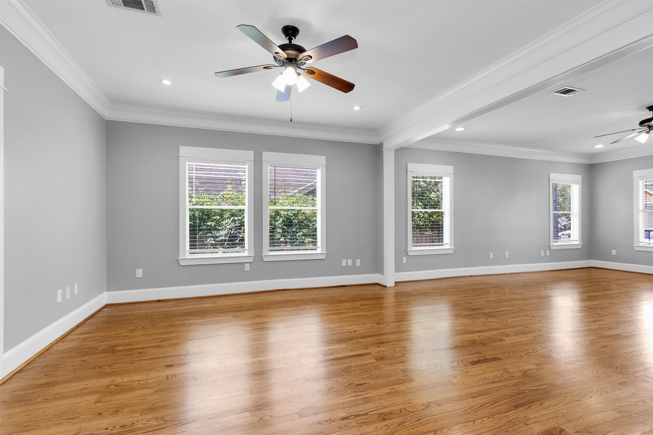 304 Vincent Street Houston, TX 77009 - Photo 9 of 36 a view of an empty room with wooden floor and a window