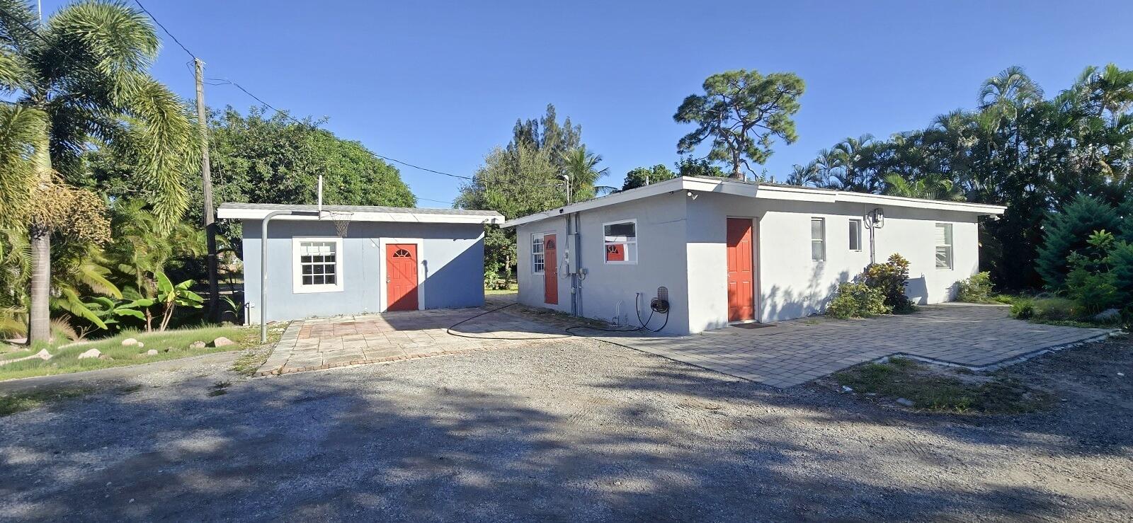 4138 Kirk Road Lake Worth, FL 33461 - Photo 4 of 11 a view of a house with a yard and garage