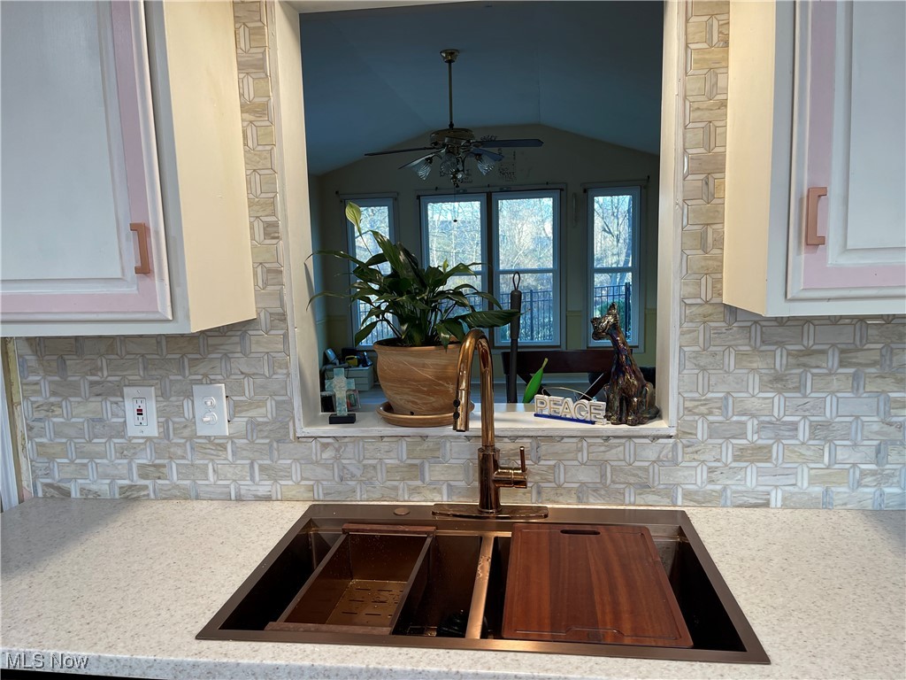170 Burns Road Elyria, OH 44035 - Photo 20 of 32 Kitchen featuring tasteful backsplash, white cabinetry, and copper sink