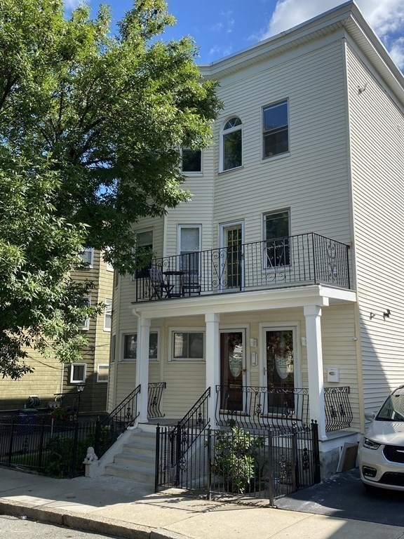 159 Walnut Street, Unit 2 Somerville, MA 02145 - Photo 1 of 10 a front view of a house with garden