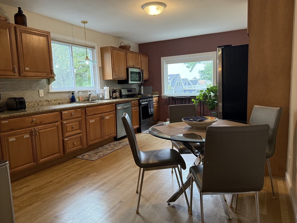 159 Walnut Street, Unit 2 Somerville, MA 02145 - Photo 2 of 10 a view of a dining room with furniture window and wooden floor