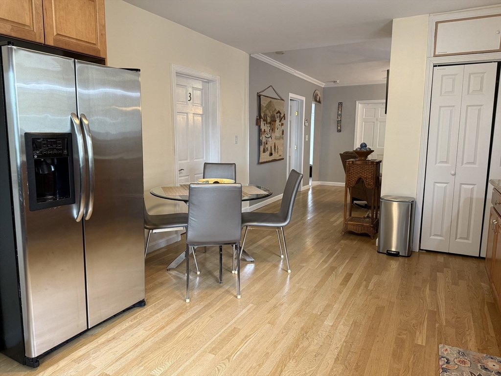159 Walnut Street, Unit 2 Somerville, MA 02145 - Photo 4 of 10 a dining room with furniture and a wooden floor
