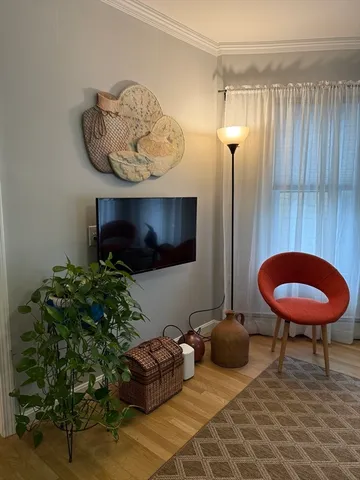 a living room with furniture and a mirror