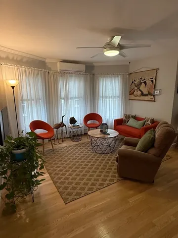 a living room with furniture chess board and a window