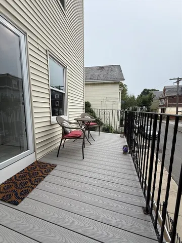 a view of a roof deck with wooden floor and fence