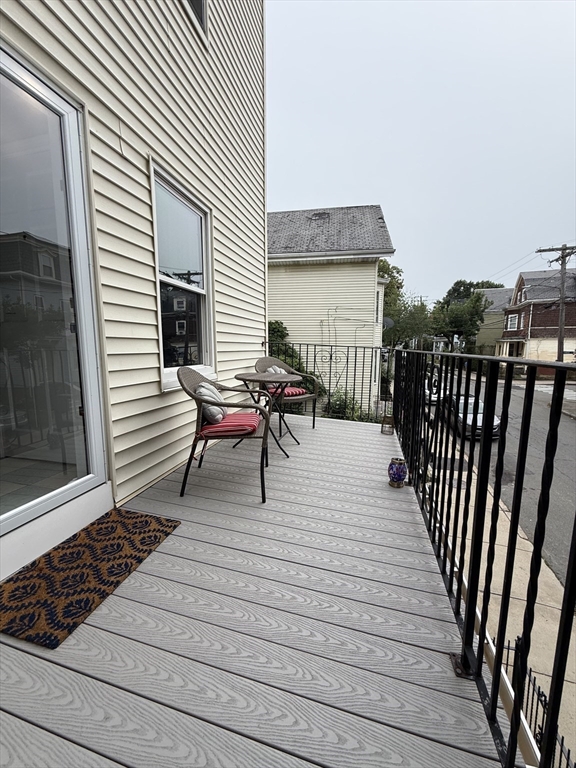 159 Walnut Street, Unit 2 Somerville, MA 02145 - Photo 9 of 10 a view of a roof deck with wooden floor and fence