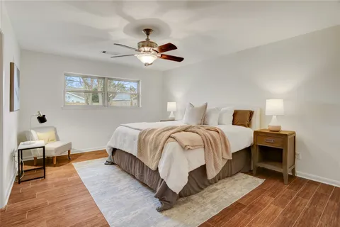 a bedroom with bed and a chandelier
