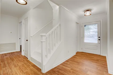 a view of a hallway view with wooden floor and staircase