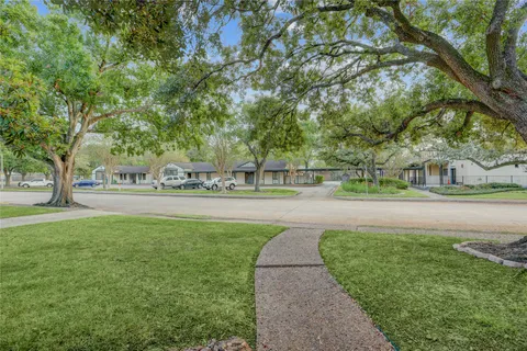 a view of large building with a lot of trees and entertaining space