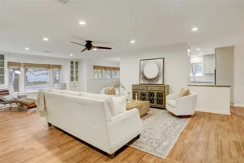 a living room with fireplace furniture and a wooden floor