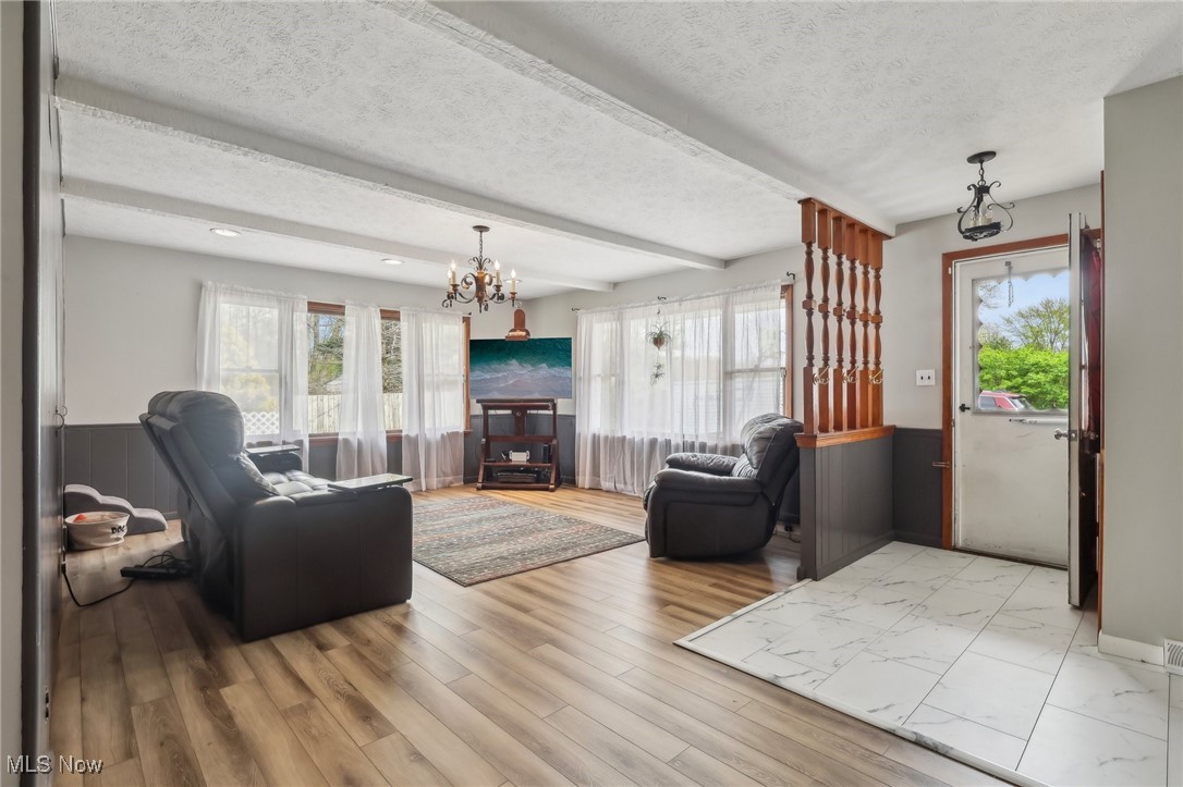 13676 Whitney Road Strongsville, OH 44136 - Photo 13 of 46 Living room featuring a textured ceiling, a chandelier, recessed lighting, and beamed ceiling