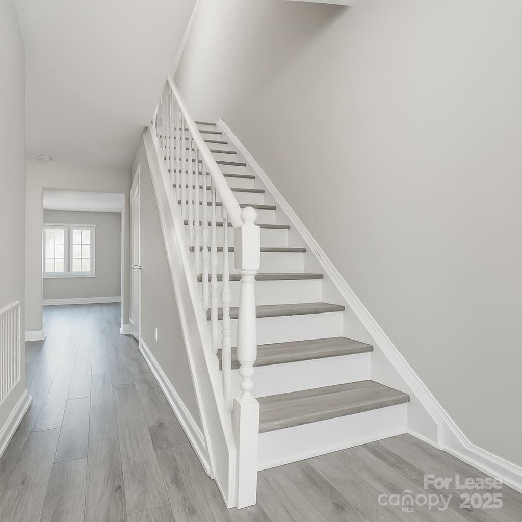 5821 Hunting Ridge Lane, Unit F Charlotte, NC 28212 - Photo 11 of 16 a view of staircase with wooden floor and white walls