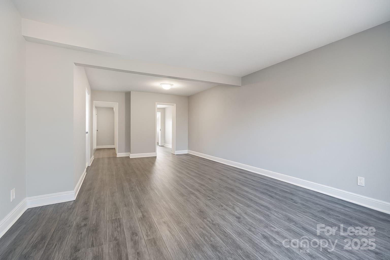 5821 Hunting Ridge Lane, Unit F Charlotte, NC 28212 - Photo 13 of 16 a view of an empty room and wooden floor