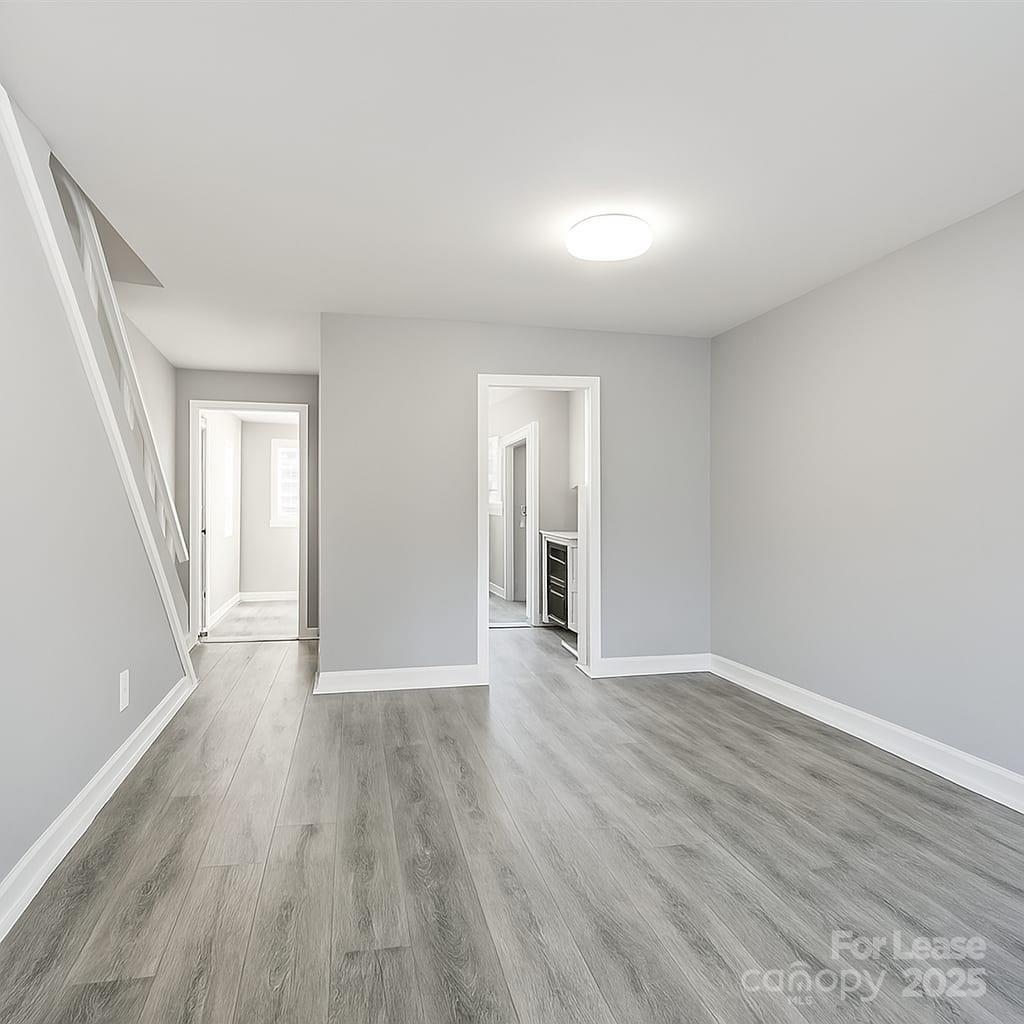 5821 Hunting Ridge Lane, Unit F Charlotte, NC 28212 - Photo 15 of 16 wooden floor in an empty room with a window