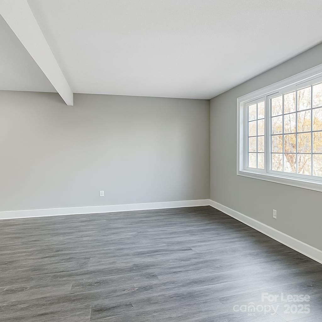 5821 Hunting Ridge Lane, Unit F Charlotte, NC 28212 - Photo 16 of 16 a view of an empty room with wooden floor and a window