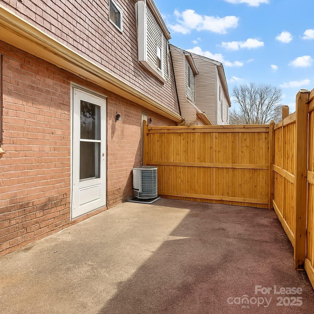 5821 Hunting Ridge Lane, Unit F Charlotte, NC 28212 - Photo 2 of 16 a view of a house with a wooden fence