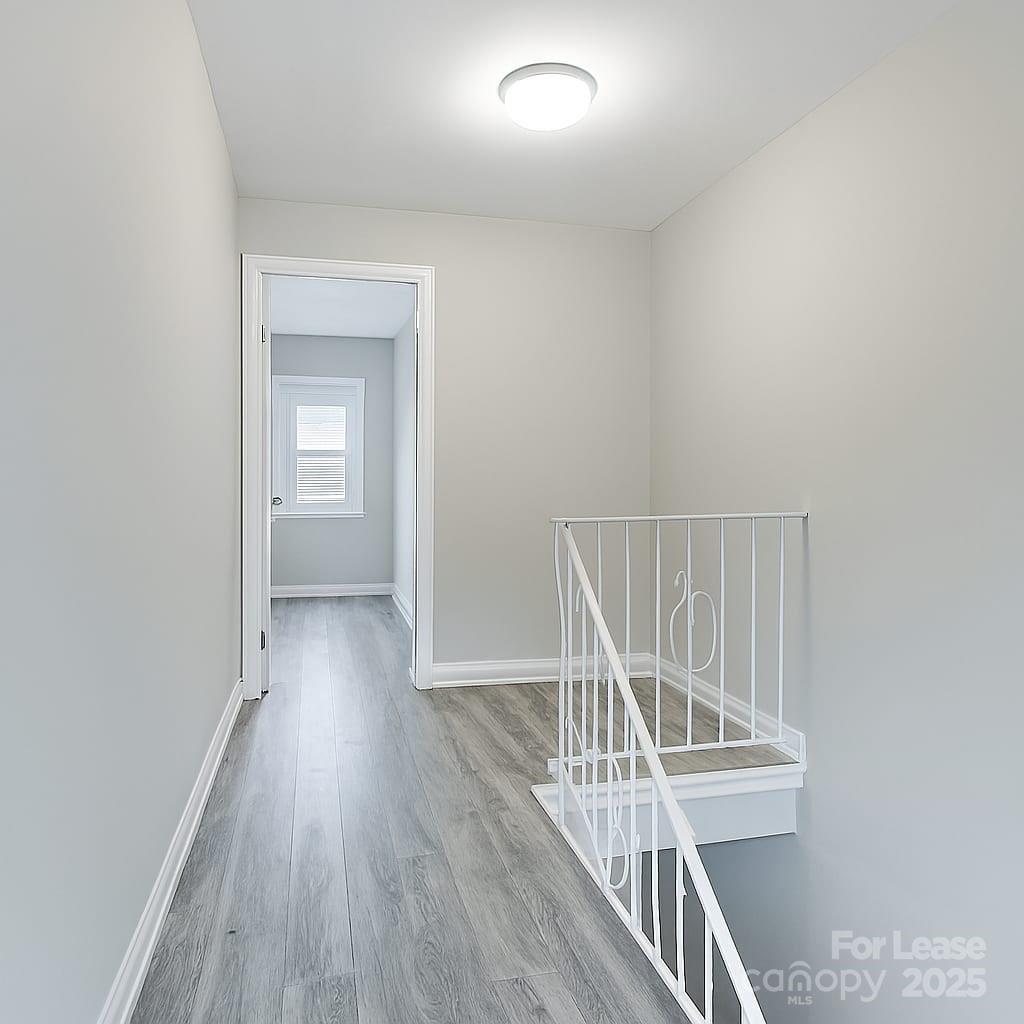 5821 Hunting Ridge Lane, Unit F Charlotte, NC 28212 - Photo 4 of 16 wooden floor in a hall with a window