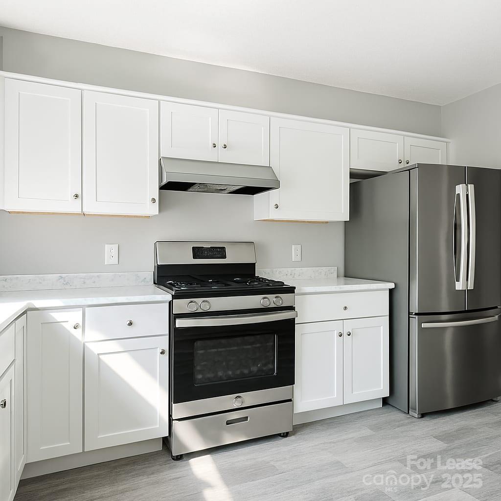 5821 Hunting Ridge Lane, Unit F Charlotte, NC 28212 - Photo 8 of 16 a kitchen with white cabinets and stainless steel appliances