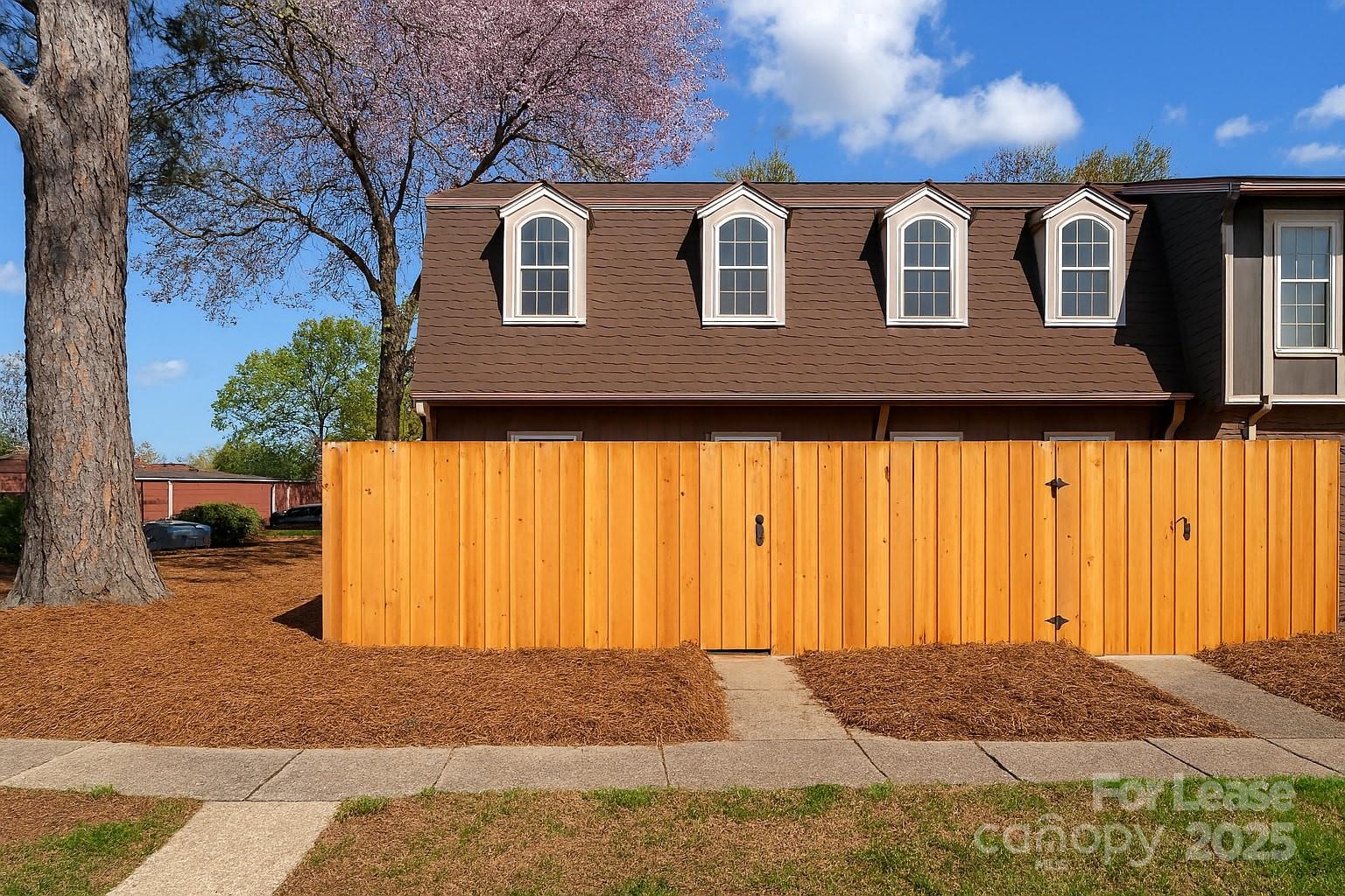 5821 Hunting Ridge Lane, Unit F Charlotte, NC 28212 - Photo 9 of 16 a front view of a house with a yard