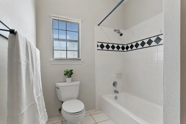 a bedroom with a bed and a potted plant