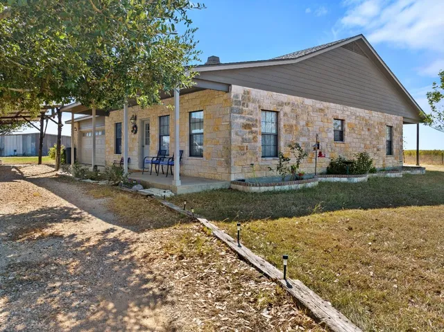a view of a house with a backyard