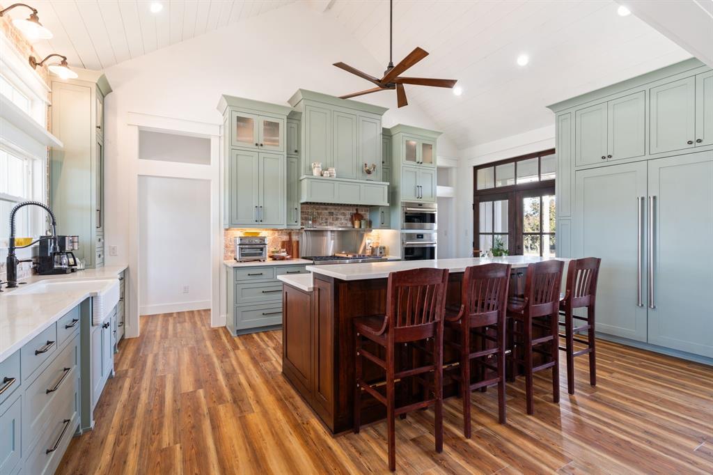 714 Bethel Road Waxahachie, TX 75167 - Photo 11 of 40 a kitchen with a table chairs refrigerator and microwave