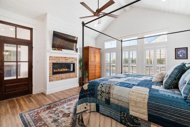a bedroom with a bed window and flat screen tv