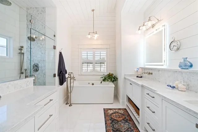 a bathroom with a tub sink and mirror