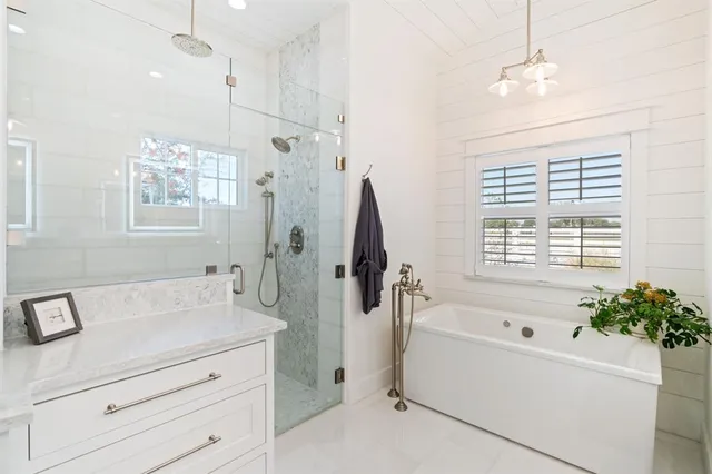 a bathroom with a bathtub and shower