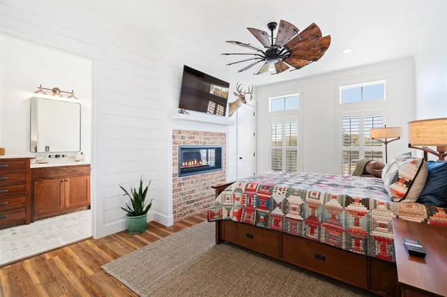 a bedroom with a bed a flat screen tv and a couch